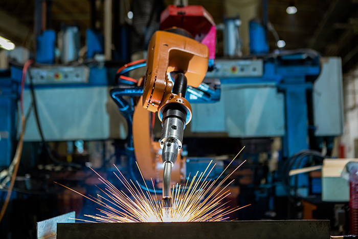 Robots welding in a car factory. Welding car body